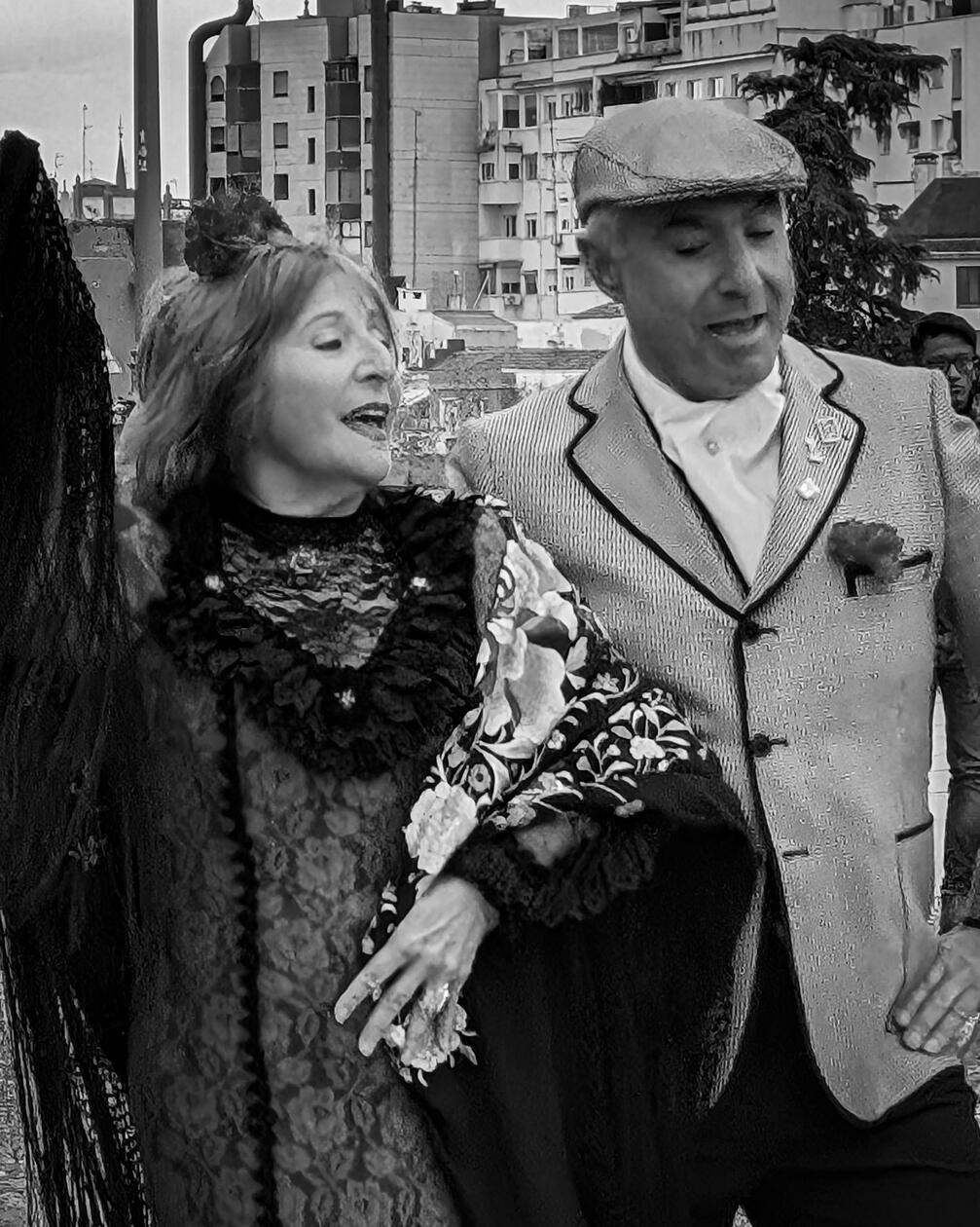 Vintage Street Photography Capturing Traditional Spanish Costume and Joyful Urban Dance in Black and White